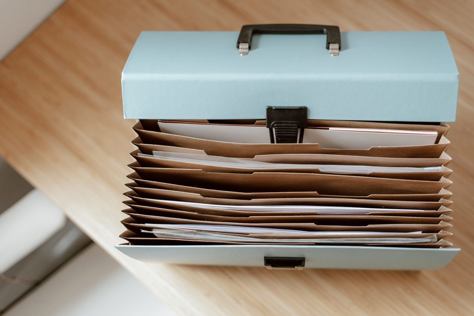 Carpetas y documentos ordenados sobre una mesa de trabajo.